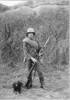 Portrait, Charles Pratt standing in front of an earth bank, in Territorial's uniform, with a rifle and bayonet affixed, and a dog. - No known copyright restrictions