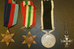 Medals (with ribbons) including 1939-45 Star, Italy Star, New Zealand War Service Medal. And the New Zealand Memorial Cross with Gordon Davidson's name and serial number in the reverse side, no ribbon attached, in its place a short chain. - This image may be subject to copyright