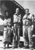 3 airmen standing under wing of aeroplane, John Rudling on left smiling - This image may be subject to copyright