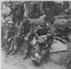 Group, soldiers on a bank resting, winter gear, identified men Henry McElroy (20045) (right) with Sergeant Tucker (centre) and Sergeant McCoy (left). Photograph supplied by Mrs Smith. - This image may be subject to copyright