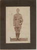 E. Welch, full length portrait, boots, bandolier, hat in hand - No known copyright restrictions