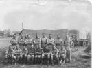 Group, WW2, 17 soldiers, 1 New Zealand Supply Company arranged in front of a tent, military truck at back, Mo Mitchell (36256) is 6th from the left, back row - This image may be subject to copyright