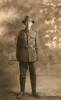 Portrait, WW1, studio photograph, painted backdrop, trees, full length, uniform, hat, holding cane behind him, William Robson was at Aerodrome Camp, Heliopolis, Cairo, Egypt, December 12, 1915 - No known copyright restrictions