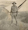 Charles Danks standing outside a tent in desert uniform - This image may be subject to copyright