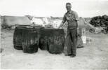 Image of Charles Bennet with barrels near tenet provided by Paul Baker June 2012 - This image may be subject to copyright