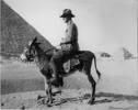 James Q Cameron sitting on a donkey in front of pyramids - No known copyright restrictions