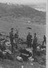 Group, WW2, Greece, soldiers standing with gear in crates and bags 'Mt Olympus note the snow on top. Boys round a field kitchen how do you like it'. - This image may be subject to copyright