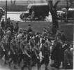 Group, soldiers marching in a street, Norman (middle front row) on parade in Christchurch prior to leaving for Egypt in August 1940 - This image may be subject to copyright