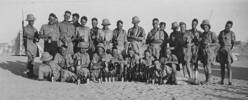 Large group photo. No. 9 Platoon, 3 Company, 27 Machine Gun Battalion, Maadi Camp, Egypt, with bottles of beer. Written on the reverse of the photo: 'This photo was taken a month or so before our Battalion went to Greece and Crete in 1940.' - This image may be subject to copyright