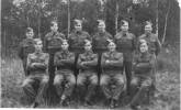 Group, WW2, Stalag VIIIB POW Camp, 11 soldiers formally arranged, forest in the background, Nicoll is seated in front row, second from right. - This image may be subject to copyright