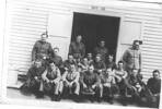 Group photo [WW2 ?], soldiers informally photographed outside, in front of a wooden shed numbered 16 - This image may be subject to copyright