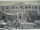 Stretchers with men being loaded into ambulances in front of Grand Central Hotel Helwan Egypt (cWW2) from collections of Jack and Madge (nee Tyson) Callaghan - This image may be subject to copyright
