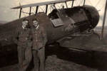 Group, 2 airmen standing beside bi plane aircraft unknown man on left and Alec (James) Johnston (right) , location/date unknown (kindly provided by family) - This image may be subject to copyright