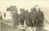 Group WW1, 6 men taken in field, 2 in trench coats, 2 with enamel cups, stone edging, tents. Andrew Watson in camp extreme right - No known copyright restrictions