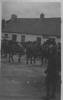 Horses of the Auckland Mounted Rifles (in France?) lined up in front of terraced houses; boy in foreground. - No known copyright restrictions