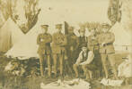 Group, WW1, soldiers standing in front of tents - Hugh Mullins (1st on left, standing, arms folded). Inscribed on verso: 'Main Body Hugh Mullins'. (Courtesy of Carlyn Milicich, 2005) - No known copyright restrictions