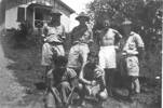 Group 5 soldiers and 1 Fijian woman, Fiji, in front of house, Ian in shorts. - This image may be subject to copyright