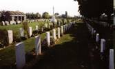 Wide view of Cross of Sacrifice and gravestones at Forli cemetery - This image may be subject to copyright