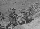 Group, WW2, Greece, soldiers walking uphill with rifles and a donkey loaded with gear 'The tramp over Keas Island will I ever forget it'. - This image may be subject to copyright