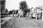 Group, WW2, 3 soldiers leaning against a tank, other soldiers in the background, second tank behind a tree, San Georgio, Italy - This image may be subject to copyright