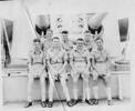 Group, WW2 seamen in tropical uniform sitting in front of a gun turret - This image may be subject to copyright