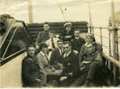 Group, May 1919, 10 people - naval, nurse, army uniformed men and women on deck of the "SS Tainui" arriving New Zealand. Archibald Duff seated, middle front in naval uniform, no hat. - No known copyright restrictions