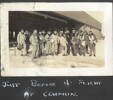 Group, WW2, RNZAF, Crumlin, London, Canada. Airmen wearing flying gear, standing in front of a hangar captioned " Just before a flight at Crumlin." (Album of Ronald Moore (NZ404554)) - This image may be subject to copyright