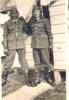 Group, 2 airmen, Levin 1941, Mervyn Jack Mills (NZ414321) and Alick Mewa (NZ414320) awhile at aircrew training in Levin in 1941, standing in front of Hut 98, wearing flying helmets, gloves and boots. - This image may be subject to copyright
