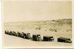 Convoy of trucks, halted in desert - This image may be subject to copyright