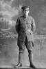 Full length portrait of Sergeant Ashton, probably Sergeant Norman Ashton, Reg No 24323, of the 17th Reinforcements, Auckland Infantry Regiment, J Company, (Corporal in the Roll of Honour), killed in action in France on 4 October 1917, at the Battle of Passchendaele. (Photographer: Herman Schmidt, 1916). Sir George Grey Special Collections, Auckland Libraries, 31-A1811. No known copyright.