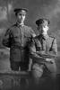 Portrait of 2 men in military uniform, Rifleman James Brewin, Reg No 25/489, (sitting) of the New Zealand Rifle Brigade, 3rd Battalion, A Company. (Photographer: Herman Schmidt, 1916). Sir George Grey Special Collections, Auckland Libraries, 31-B138. No known copyright.