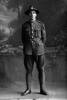 Full length portrait of Corporal Francis Thomas McAneny Reg No 52250 Auckland Infantry Regiment - A Company (Photographer: Herman Schmidt, 1917). Sir George Grey Special Collections, Auckland Libraries, 31-A3323. No known copyright.