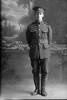 Full length portrait of Rifleman Lewis Arthur William Beecroft, Reg No 24/1594, of the New Zealand Rifle Brigade, 3rd Reinforcements to the 2nd Battalion, - F Company. (Photographer: Herman Schmidt, 1916). Sir George Grey Special Collections, Auckland Libraries, 31-B1444. No known copyright.