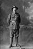 Full length portrait of Edwin George Bartlett, Reg No 40482, Auckland Infantry Regiment, - A Company, 23rd Reinforcements. (Photographer: Herman Schmidt, 1916). Sir George Grey Special Collections, Auckland Libraries, 31-B2379. No known copyright.