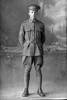 Full length portrait of Corporal (later Sergeant) Charles Lindsay Bevins, Reg No 40434, Specialist Company, Signal Section, 24th reinforcements. (Photographer: Herman Schmidt, 1916). Sir George Grey Special Collections, Auckland Libraries, 31-B2386. No known copyright.