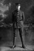 Full length portrait of Rifleman Ernest James Daniels, Reg No 24/112, 2nd New Zealand Rifle Brigade, - A Company. (Photographer: Herman Schmidt, 1915). Sir George Grey Special Collections, Auckland Libraries, 31-D352. No known copyright.