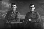3/4 portrait of cousins Private 'Driver' Dudley Hancock Doidge 12760 3rd NZDAC, NZFA (right) who embarked with the 13th reinforcements NZFA 27 May 1916, and Sergeant Herbert Doidge 40528 (left), in the uniform of the 16th Waikato, but who embarked as a private with the 23rd reinforcements, A coy, Auckland infantry regiment on 14 March 1917 (Photographer: Herman Schmidt, 1916). Sir George Grey Special Collections, Auckland Libraries, 31-D406. No known copyright.