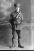 Full length portrait of Sergeant McCabe  [possibly 13/3055 George Leo McCabe] (Photographer: Herman Schmidt, 1916). Sir George Grey Special Collections, Auckland Libraries, 31-C181. No known copyright.