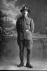 Full length portrait of Lance Corporal Henry Richard Cowan, Reg No. 23322, of the 7th Reinforcements to the 1st Battalion, - E Company, New Zealand Rifle Brigade (Photographer: Herman Schmidt, 1916). Sir George Grey Special Collections, Auckland Libraries, 31-C321. No known copyright.
