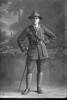 Full length portrait of 2nd Lieutenant Andrew Leonard Caughy, Reg No 38829, of the Auckland Infantry Regiment, - A Company, 29th Reinforcements (Cap badge is 25th R. but collar badges are 29th R). (Photographer: Herman Schmidt, 1917). Sir George Grey Special Collections, Auckland Libraries, 31-C3621. No known copyright.