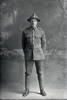 Full length portrait of Lance Corporal A Edwards, of the New Zealand Rifle Brigade. (Photographer: Herman Schmidt, 1916). Sir George Grey Special Collections, Auckland Libraries, 31-E1978. No known copyright.