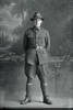 Full length portrait of Private T J McEldowney of the New Zealand Mounted Rifles, 11th Reinforcements (Photographer: Herman Schmidt, 1916). Sir George Grey Special Collections, Auckland Libraries, 31-E1983. No known copyright.