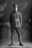 Full length portrait of Lance Corporal John William Gow, Reg No 11462, of the Auckland Infantry Battalion, - A Company, 12th Reinforcements. (Photographer: Herman Schmidt, 1916). Sir George Grey Special Collections, Auckland Libraries, 31-G495. No known copyright.