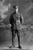 Full length portrait of Corporal Le Grice of the 3rd (Auckland) Regiment, Auckland Infantry Regiment, wearing the proficiency badge of an assistant instructor in signalling and crossed rifles of a marksman. (Photographer: Herman Schmidt, 1916). Sir George Grey Special Collections, Auckland Libraries, 31-G523. No known copyright.