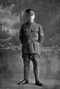 Full length portrait of Corporal Gallagher of the 22nd Reinforcements. An Auckland Rugby Union catalogue from 1918 identifies him as Dave Gallaher, captain of the famous All Blacks. Died of wounds in France on 4 October 1917, at the battle of Passchendaele (Photographer: Herman Schmidt, 1917). Sir George Grey Special Collections, Auckland Libraries, 31-G2778. No known copyright.