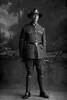 Full length portrait of Lance Corporal Benjamin McKenzie, Reg No 31692, of the Auckland Infantry Battalion, A Company, 19th Reinforcements. (Photographer: Herman Schmidt, 1916). Sir George Grey Special Collections, Auckland Libraries, 31-K2814. No known copyright.