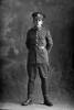 Full length portrait of Private Thomas McKnight, Reg No 56077, of the Specialist Company (Signal Section), 30th Reinforcements. (Photographer: Herman Schmidt, 1917). Sir George Grey Special Collections, Auckland Libraries, 31-K4403. No known copyright.