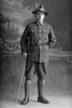 Full length portrait of Private Vivian Leonard Gittos, Reg No 3/2509, of the New Zealand Medical Corps wearing 4 years of Service Chevrons and campaign medals (Photographer: Herman Schmidt, ). Sir George Grey Special Collections, Auckland Libraries, 31-G4265. No known copyright.