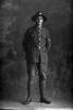 Full length portrait of Corporal Frank Guscott, Reg No 15532, of the 30th Reinforcements, F Company. (Photographer: Herman Schmidt, 1917). Sir George Grey Special Collections, Auckland Libraries, 31-G4290A. No known copyright.