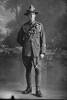 Full length portrait of Gunner Arthur Bramwell Hudson, Reg No 2/2844, of the New Zealand Field Artillery, No. 5 Field Battery (2nd Field Artillery Brigade). (Photographer: Herman Schmidt, ). Sir George Grey Special Collections, Auckland Libraries, 31.H650. No known copyright.